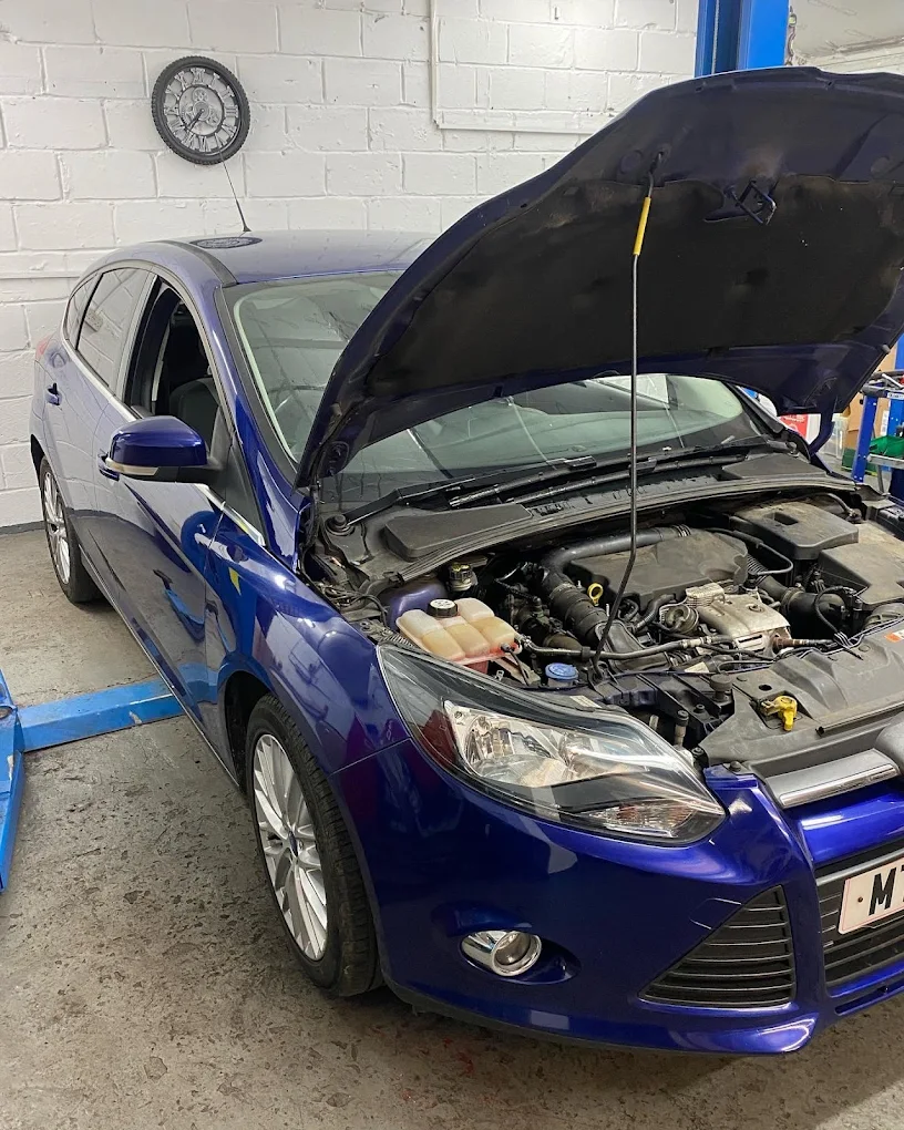 Mechanic working on car bonnet